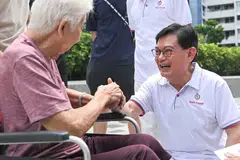 Deputy Prime Minister Heng Swee Keat greeting residents at a walkabout at Block 216 Bedok Food Centre on May 1.