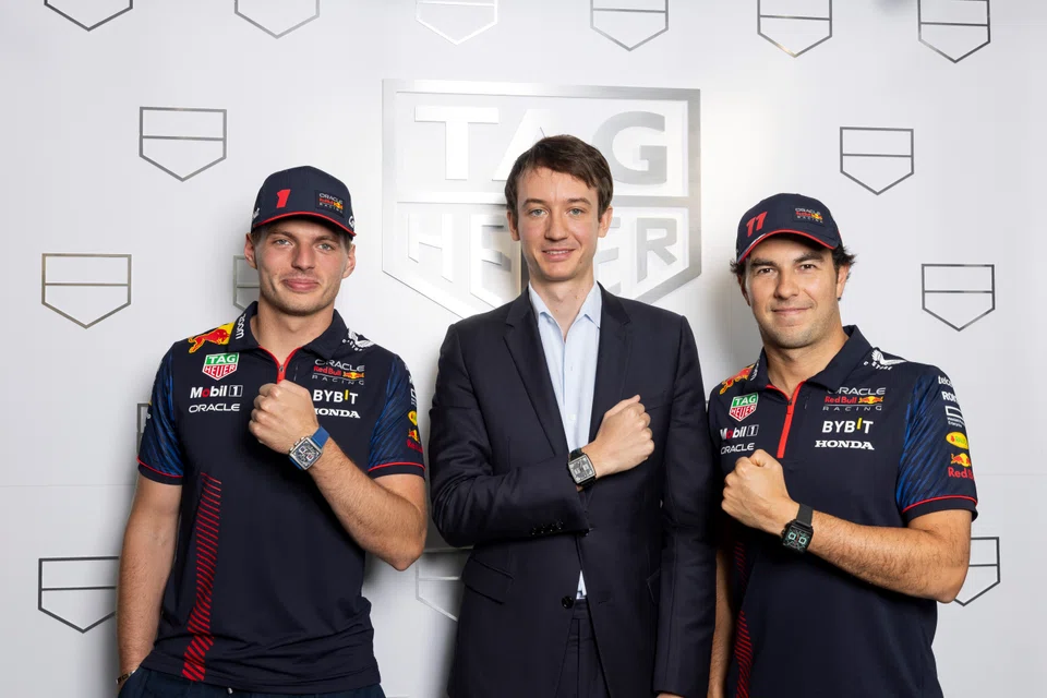 Oracle Red Bull Racing team members Max Verstappen (left) and Sergio Perez (right), with Tag Heuer CEO Frederic Arnault, at the launch of the Monaco Chronograh Night Driver.