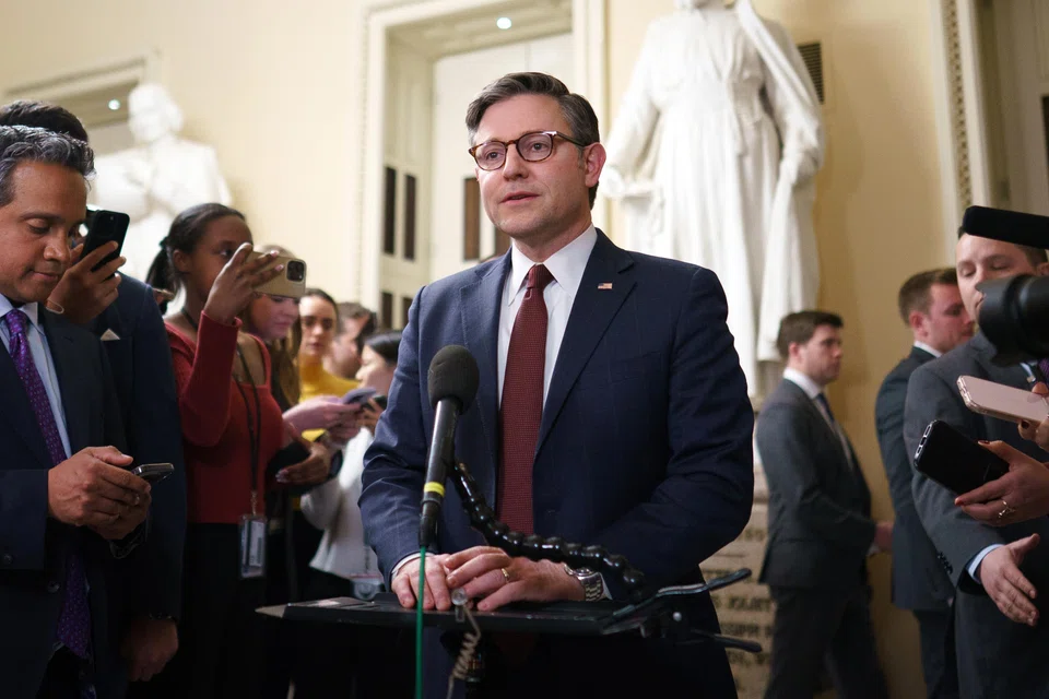 US House Speaker Mike Johnson (centre) speaks to the media after the spending bill was passed in the House of Representatives at the US Capitol in Washington, D.C., Feb 25, 2025. 