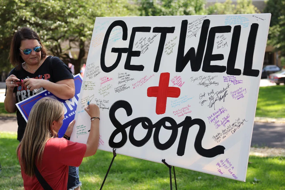 People sign get-well messages for Republican presidential candidate and former US President Donald Trump ahead of the Republican National Convention at Zeidler Park in Milwaukee, Wisconsin, US, July 14, 2024. 