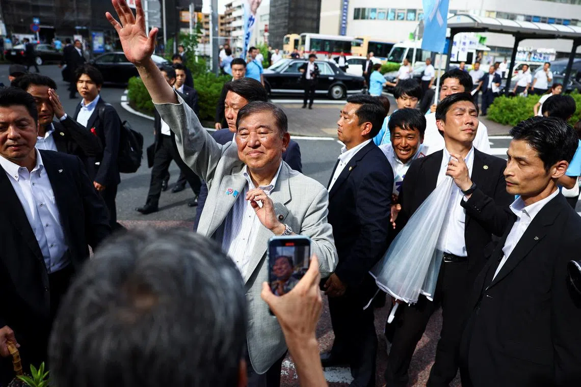 By removing the uncertainty around tariffs, Ishiba (centre, in grey) will finally have done some good for the country.
But he will leave Japan in a weaker position than when he took office.