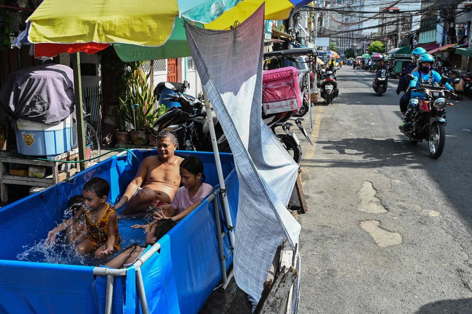 Filipinos cool off in a makeshift pool on a hot day in Manila. The Philippines hit over 38 deg C in April and May, amid a record-breaking heatwave that swept South-east Asia.