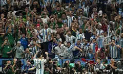 Argentina's Lionel Messi celebrates scoring his team's first goal against Mexico in front of jubilant supporters.a 