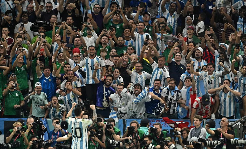 Argentina's Lionel Messi celebrates scoring his team's first goal against Mexico in front of jubilant supporters.a 