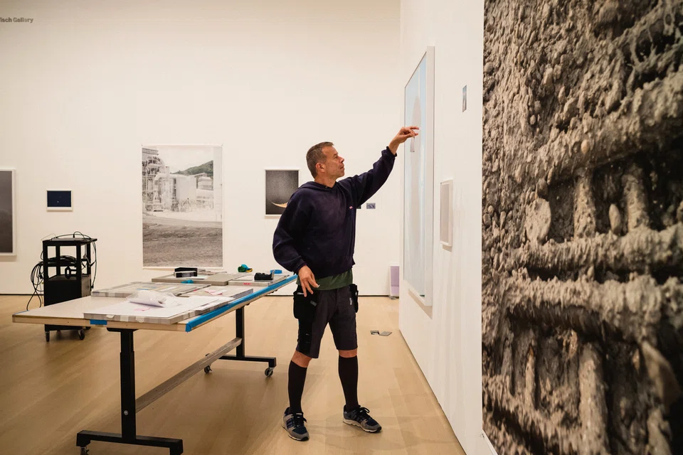 The German photographer and video artist Wolfgang Tillmans works on his exhibition 'To Look Without Fear', a career retrospective at the Museum of Modern Art in New York.