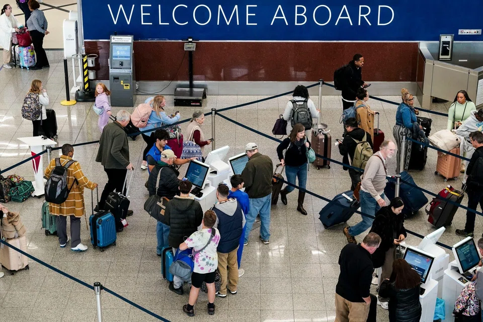 Travellers wait in line at Hartsfield-Jackson Atlanta International Airport (ATL) in Atlanta, Georgia, Nov 27, 2024. AAA projects 79.9 million travellers will head 50 miles or more from home over the Thanksgiving holiday travel period.