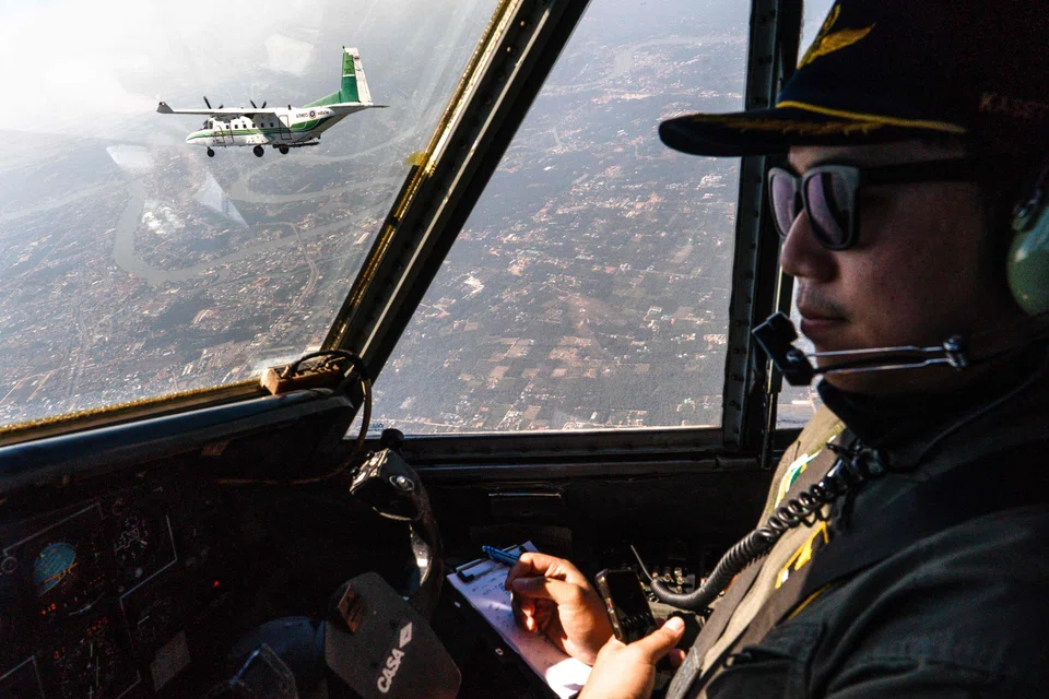 A pilot flying next to another aircraft from Thailand's Royal Rainmaking department taking part in a mission to displace pollution by spraying icy water in the air on the outskirts of Bangkok, Thailand, Jan 15, 2025.