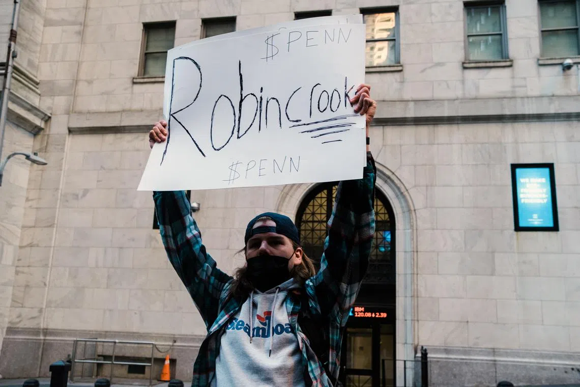 A protester on Robinhood's decision to impose trading limits on GameStop and other stocks in 2021.