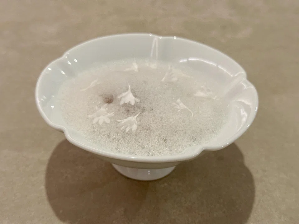 Clear chicken broth filled with chicken-mushroom meatloaf and glutinous rice.