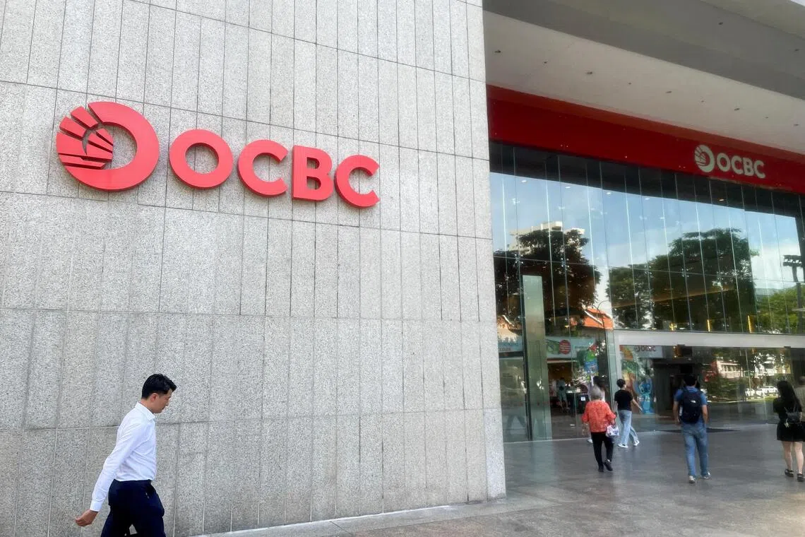 People walk in front of the Oversea-Chinese Banking Corp (OCBC) headquarters in Singapore, November 7, 2025. REUTERS/Yantoultra Ngui