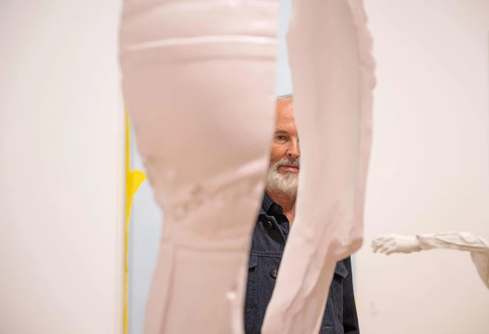Austrian artist Erwin Wurm poses next to works during the preview of his 70th-birthday retrospective at the Albertina Modern museum in Vienna.