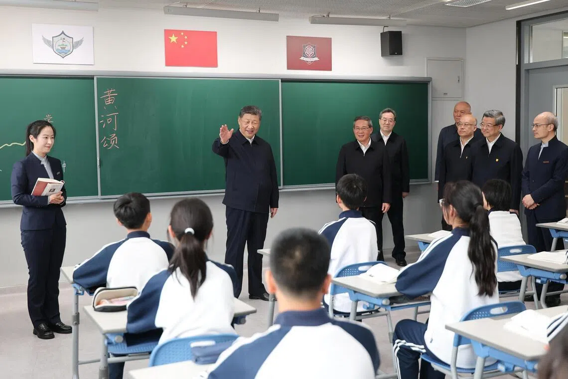 Chinese President Xi Jinping talks with students in a classroom at a high school, during an inspection tour of Xiongan New Area in Hebei province on Mar 23.