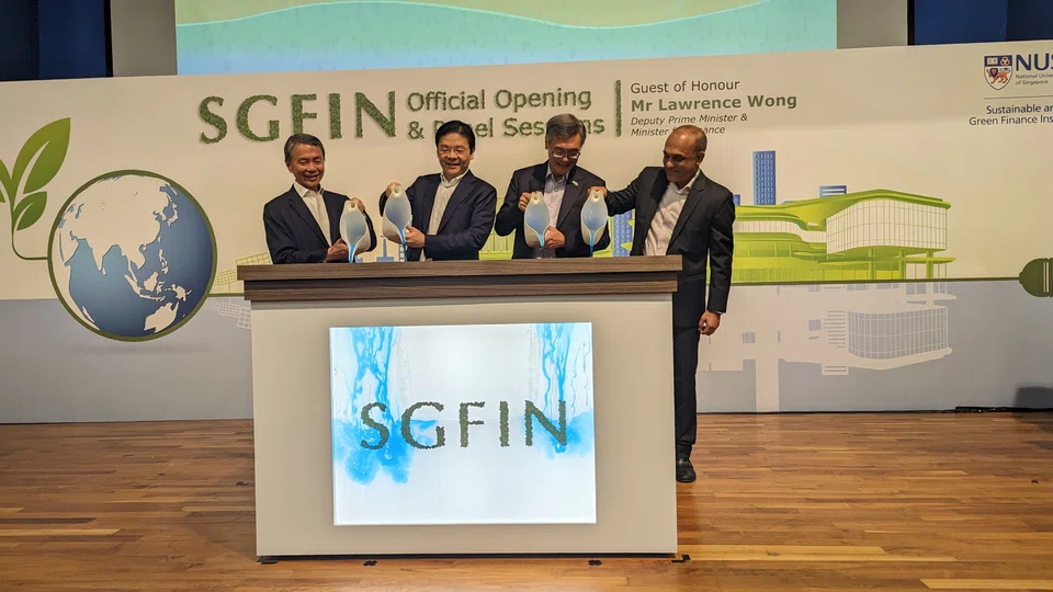 Deputy Prime Minister Lawrence Wong (second from left) at the launch of the National University of Singapore's Sustainable and Green Finance Institute. With him are NUS board of trustees chairman Hsieh Fu Hua (extreme left), NUS President Tan Eng Chye (second from right), and the institute's managing director, Sumit Agarwal.