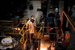 A worker oversee molten iron during cookware production at a factory in South Pittsburg, Tennessee. 