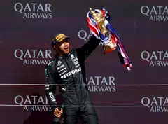 Mercedes driver Lewis Hamilton celebrating with his trophy on the podium after winning the British Grand Prix at Silverstone in July. 