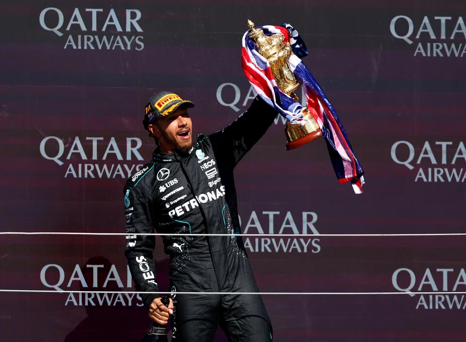 Mercedes driver Lewis Hamilton celebrating with his trophy on the podium after winning the British Grand Prix at Silverstone in July. 