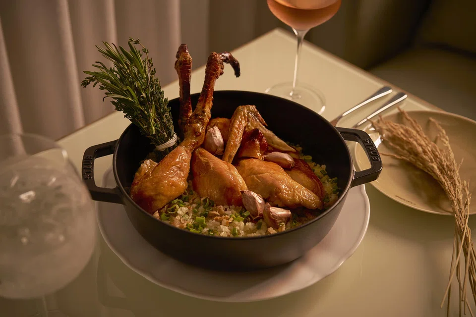 Half roasted chicken served with rice.