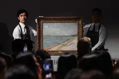 Christie’s staff hold up "Les canots amarrés" by Vincent Van Gogh from 1887, which sold at auction at Christie’s Hong Kong headquarters for HK$215 million (S$35.5 million) in Hong Kong on Sep 26.