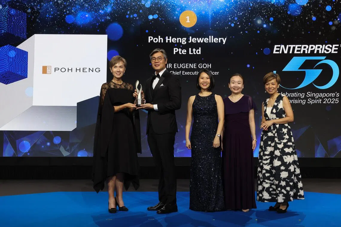 Minister Josephine Teo (left) gives out the top accolade to Poh Heng Jewellery group CEO Eugene Goh (second from left).