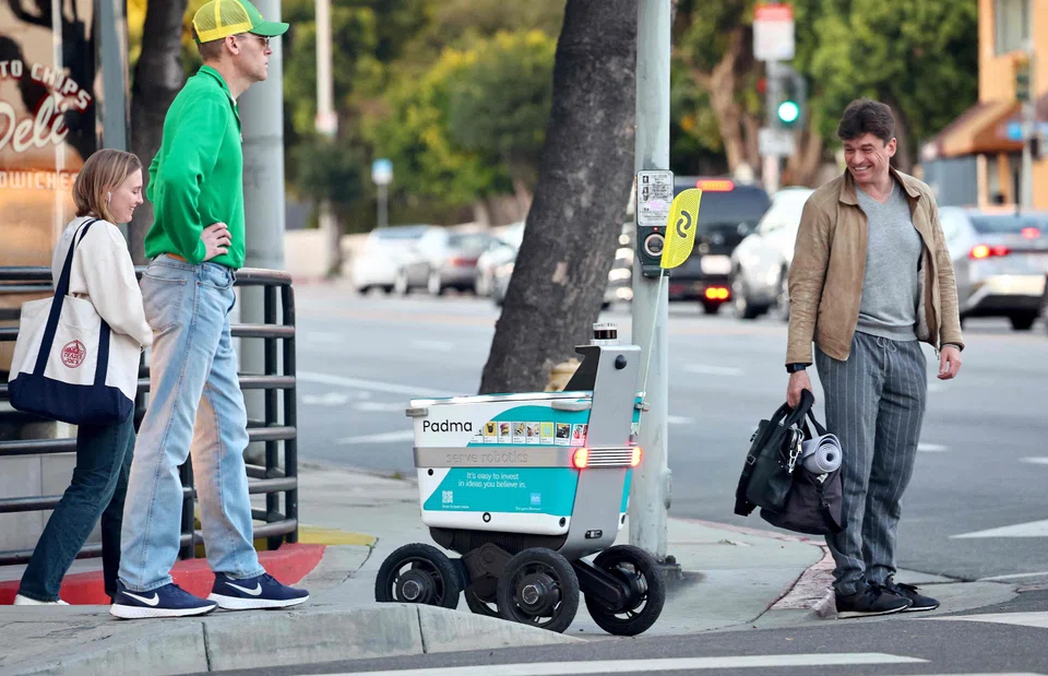 A Serve Robotics autonomous delivery robot, which uses AI and is emissions-free, crosses onto a sidewalk in West Hollywood, California..