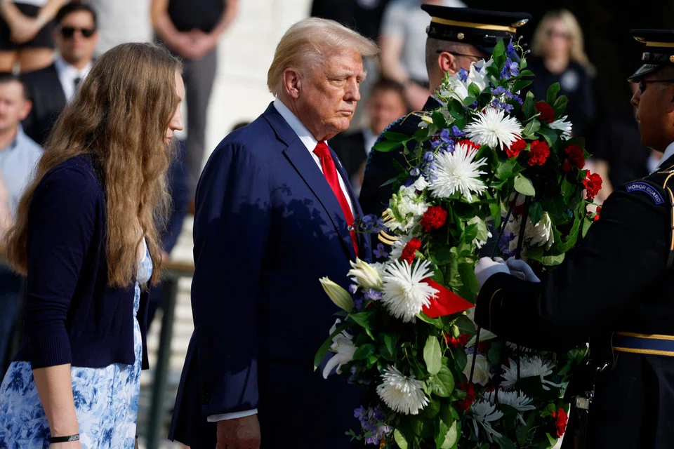 Republican presidential nominee Donald Trump stands alongside Misty Fuoco, whose sister Sgt. Nicole Gee died in Abbey Gate Bombing, at a wreath laying ceremony at the Tomb of the Unknown Soldier at Arlington National Cemetery in Arlington, Virginia, Aug 26, 2024. 