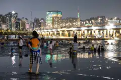 People visit at Yeouido Hangang Park at night in Seoul, South Korea, Aug 3, 2024. The Korea Meteorological Administration has issued a heat wave warning across the country on Aug 6. High nighttime temperatures can become dangerous if they prevent the human body from cooling off and recovering from daytime heat, said WHO. 