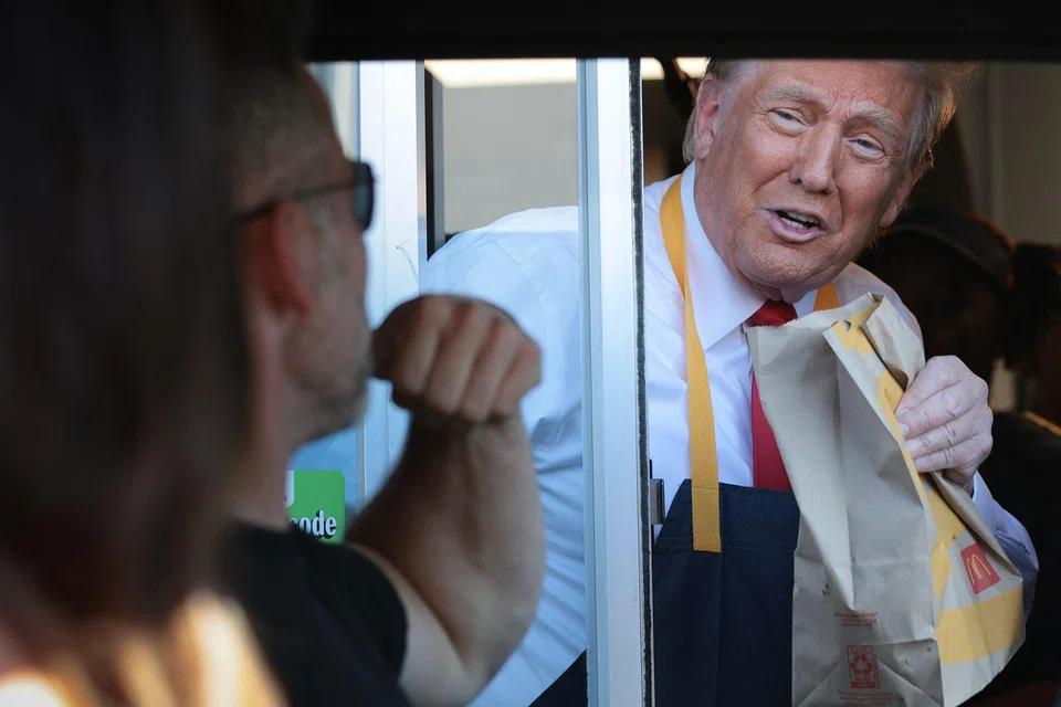 Republican presidential nominee, former US President Donald Trump works the drive-through line as he visits a McDonald's restaurant in Feasterville-Trevose, Pennsylvania, Oct 20, 2024.