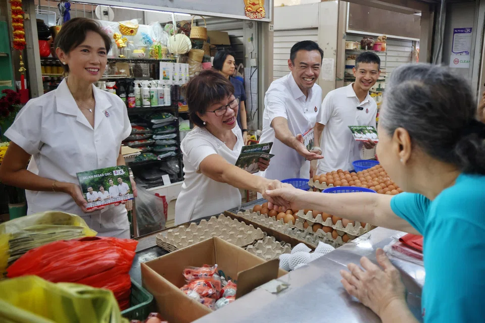 From left: PAP candidates for Jalan Besar GRC Josephine Teo, Denise Phua, Dr Wan Rizal and Shawn Loh meeting a stallholder during a walkabout at North Bridge Road Market and Food Centre. The four-member team defeated opposition coalition People's Alliance for Reform.