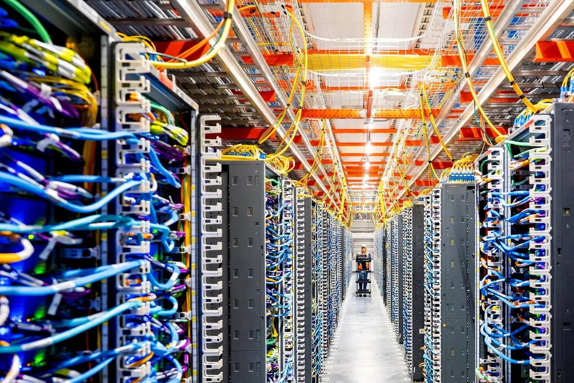  A technician works at an Amazon Web Services AI data center. 
