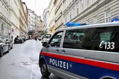 A police vehicle patrols as fans of the singer Taylor Swift gather following the cancellation of three Taylor Swift concerts at Happel stadium after the government confirmed a planned attack at the venue, in Vienna.
