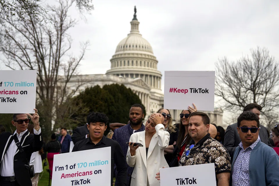Supporters of TikTok gather near the Capitol in Washington on Mar 13. Seen from Washington, the social media app is a powerful tool placed in the hands of a company with ties to a government that’s regarded as America’s leading global rival.