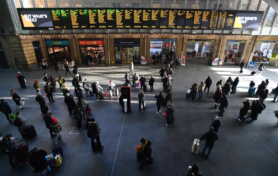 Commuters wait for trains at Kings Cross Station in London. Some 40,000 rail workers have walked out on strike in an on-going dispute over pay and conditions, causing widespread travel chaos across the UK ahead of Christmas.