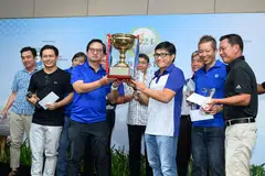 Singapore Pools CEO Lam Chee Weng (third from left) and team captain Tay Boon Khai posing with the trophy together with their fellow teammates.