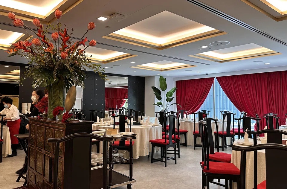 Peony Jade is decked out in fire engine-red curtains and rosewood chairs.