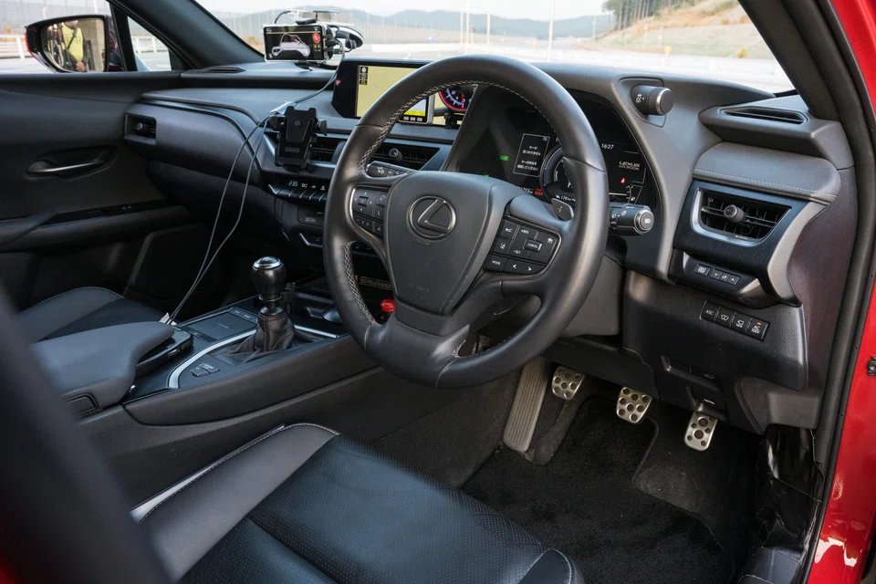 A gear shifter and clutch pedal visible in a prototype Lexus BEV without a gearbox or clutch.