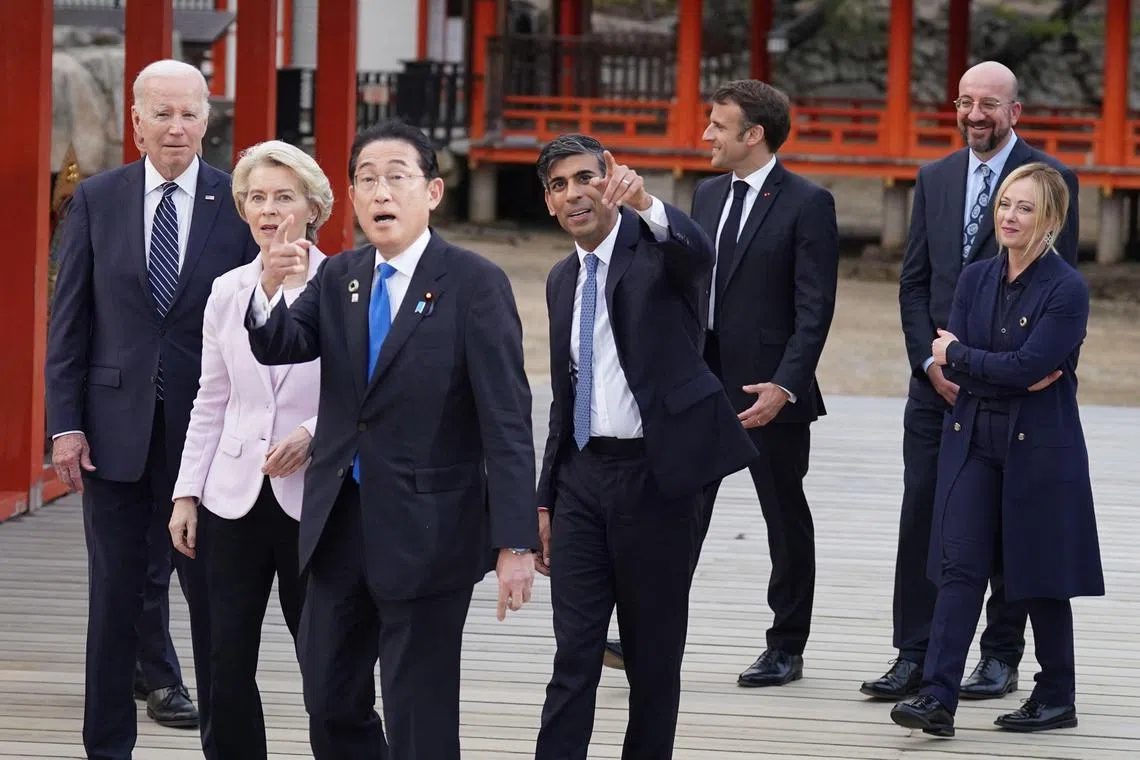 (Left to right:) US President Joe Biden, European Commission President Ursula von der Leyen, Japan's Prime Minister Fumio Kishida, Britain's Prime Minister Rishi Sunak, France's President Emmanuel Macron, European Council President Charles Michel and Italy's Premier Giorgia Meloni arrive for a group photo during a visit to the Itsukushima Shrine on Miyajima Island, at the start of the G7 summit, May 19, 2023. 