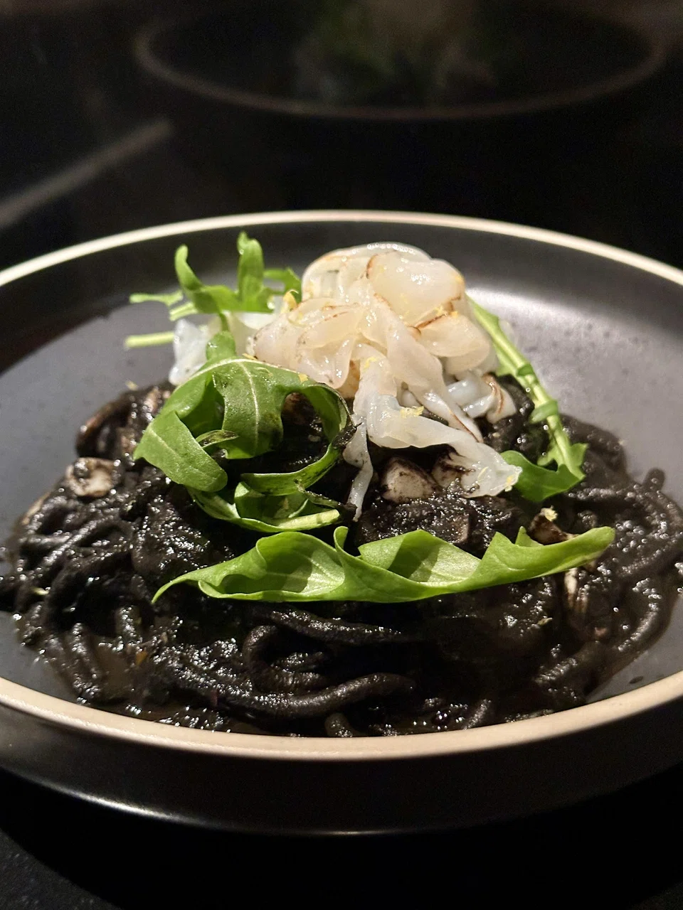Freshly pressed pasta in a rich squid ink sauce topped with Japanese squid.