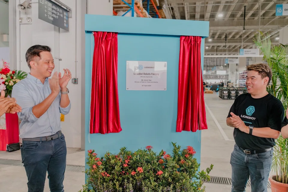 Minister of State for Trade and Industry Alvin Tan (left) and chief executive officer of LionsBot, Dylan Ng at the launch of LionsBot's new S$12 million facility in Kranji.