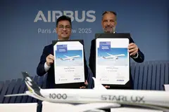 Starlux CEO Glen Chai and Airbus Executive Vice-President of Sales of Commercial Aircraft Benoit de Saint Exupery hold purchase agreement documents after Airbus secured an order for 10 long-haul jets from Taiwan's Starlux Airlines in Paris, France, June 18, 2025. 