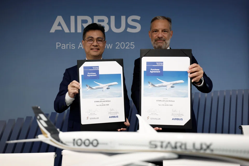 Starlux CEO Glen Chai and Airbus Executive Vice-President of Sales of Commercial Aircraft Benoit de Saint Exupery hold purchase agreement documents after Airbus secured an order for 10 long-haul jets from Taiwan's Starlux Airlines in Paris, France, June 18, 2025. 