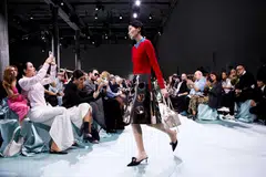 Models wore stiff shiny silver skirts, some bearing see-through decorative holes (top), colourful tights that morphed into trousers and tailored trousers as well as skirts that hung from belts.