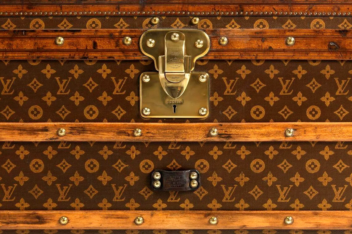 The Louis Vuitton monogram began life as an anti-counterfeit patented trademark, as seen in this 1906 low trunk.
