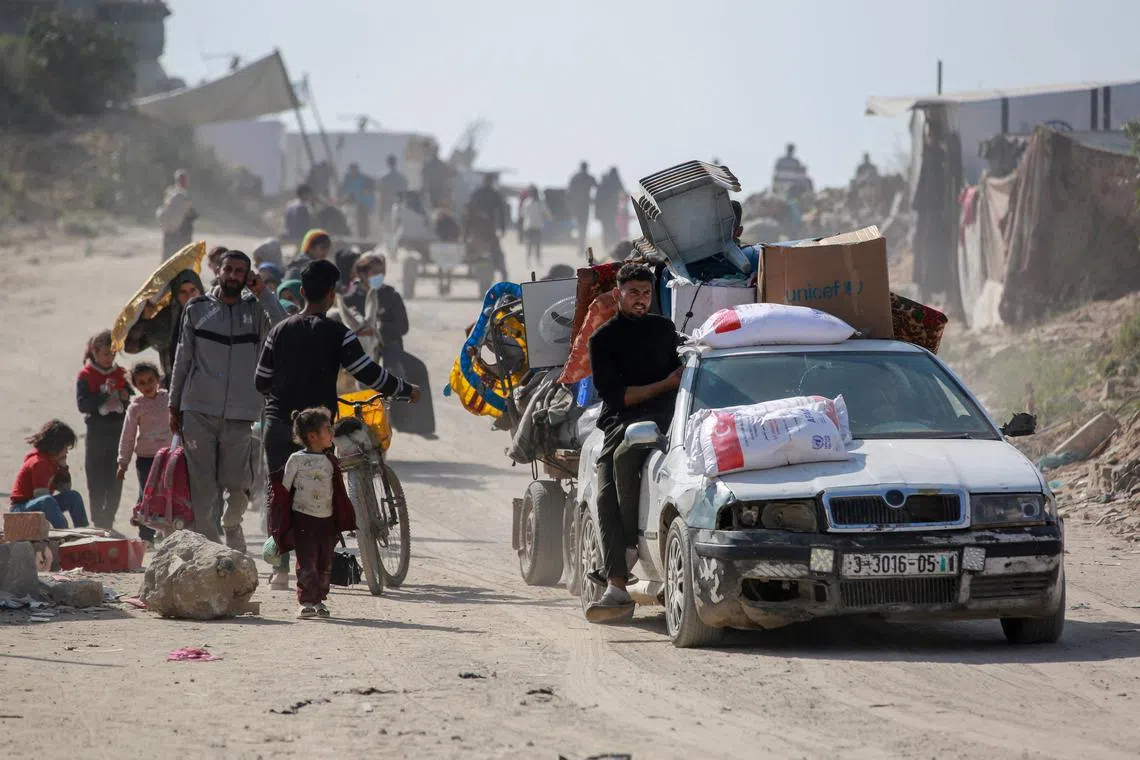 Palestinian families leave the eastern sector of the Gaza Strip on the border with Israel following Israeli airstrikes.