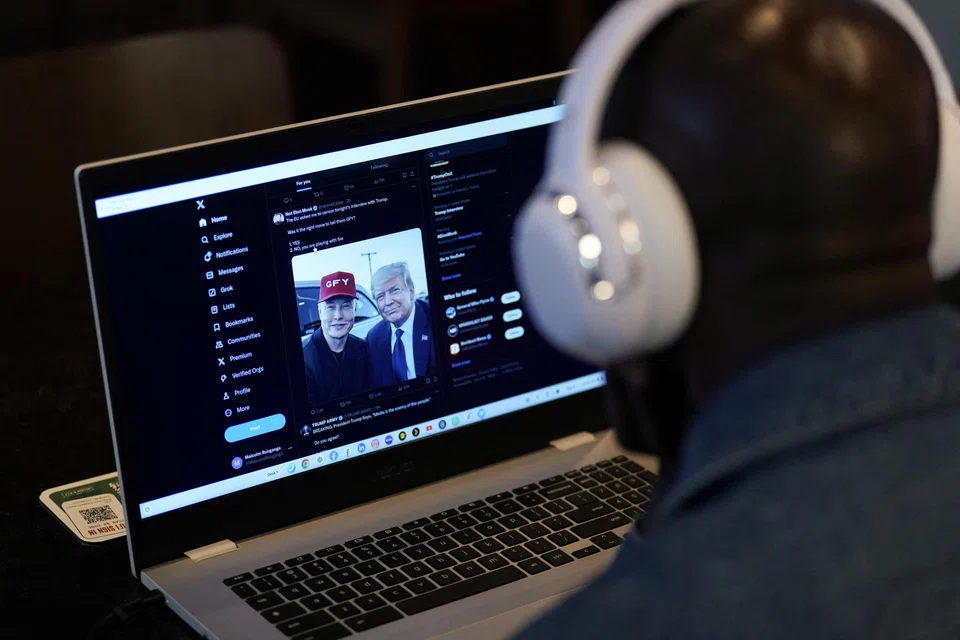 A person tries to watch on a laptop billionaire entrepreneur Elon Musk's interview with Republican presidential candidate and former US President Donald Trump on the X social media network, New York City, US, Aug 12, 2024.  