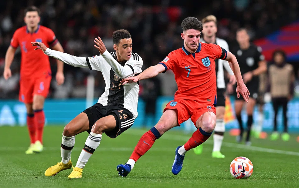 Germany's Jamal Musiala (left) and England's Declan Rice in a match at Wembley Stadium in September 2022. These two countries are among the favourites to win the World Cup in Qatar.
