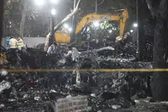  Officials inspect the site of an Air India plane crash near Sardar Vallabhbhai Patel International Airport in Ahmedabad, Gujarat, India, June 12, 2025.