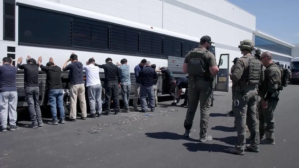 Detainees are made to stand against a bus before being handcuffed, during a raid by federal agents where about 300 South Koreans were among 475 people arrested at the site of a US$4.3 billion project by Hyundai Motor and LG Energy Solution to build batteries for electric cars in Ellabell, Georgia, Sep 4, 2025.