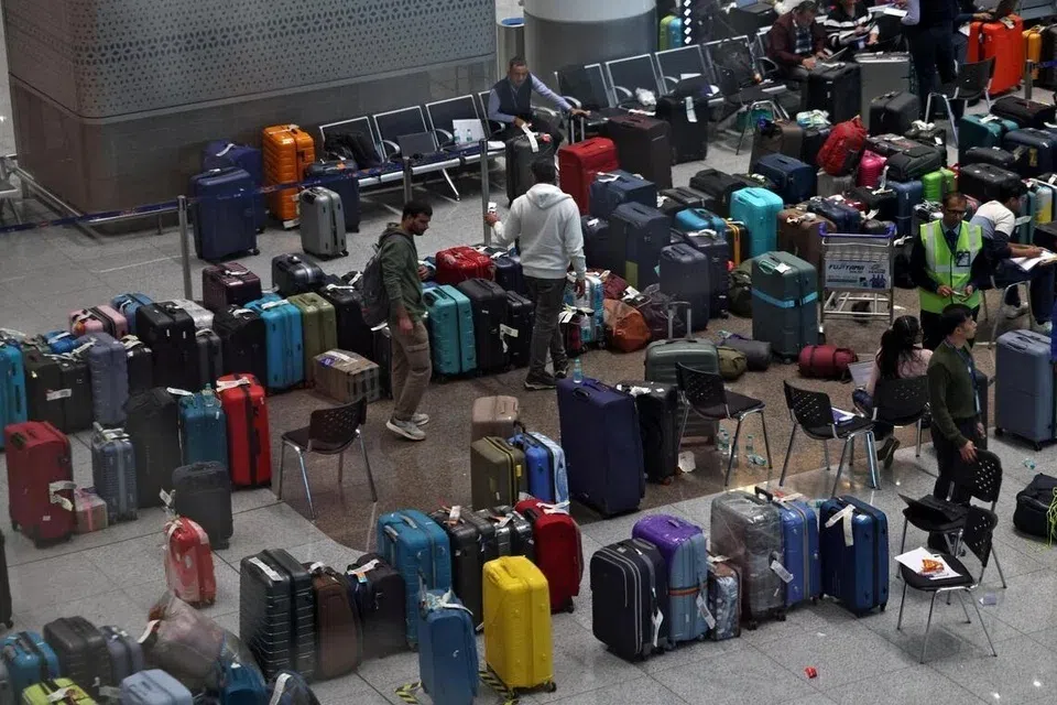 IndiGo staff tagging stranded bags and belongings of passengers following large-scale flight disruptions at New Delhi's Indira Gandhi International Airport on Dec 8.