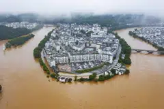 An aerial photo taken on Jun 20, 2022 showing flooded streets and buildings following heavy rains in Wuyuan, in China's central Jiangxi province.