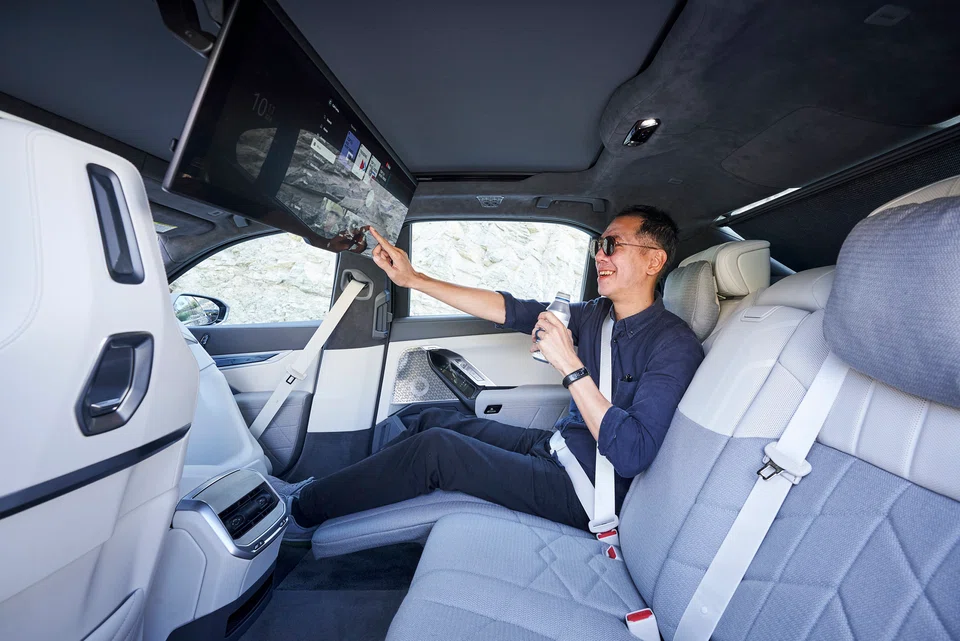 The back seat is where you can call up Theatre mode, which dims the cabin lights and draws the shades shut, while a 31-inch, 8K screen pivots down.